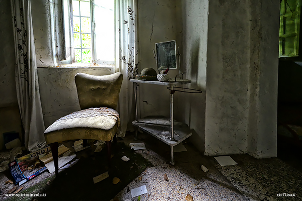 Poltroncina e tavolino con specchio nella casa abbandonata di Babbo Natale